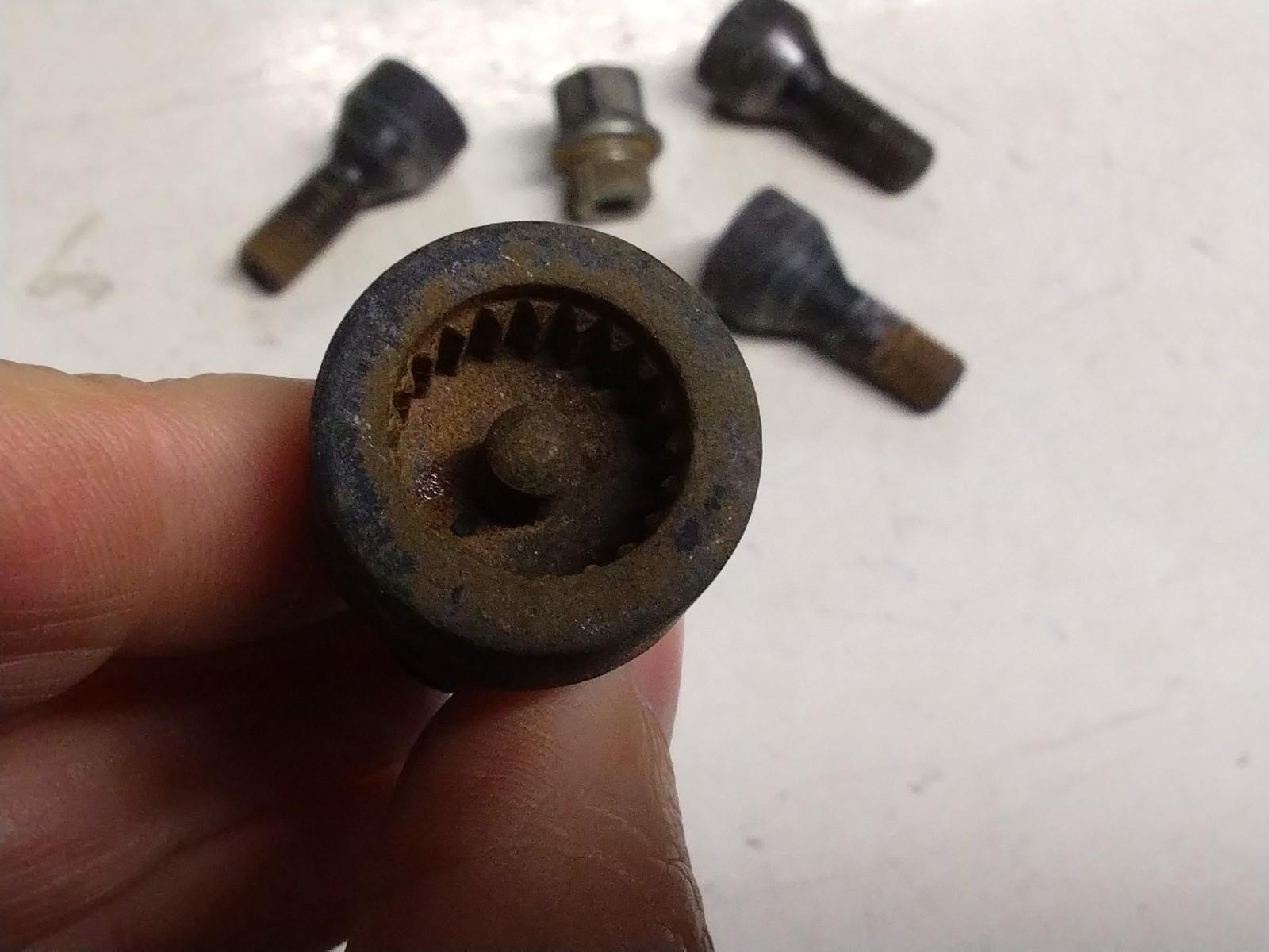 BMW E92 3 SERIES  SET OF FOUR LOCKING WHEEL NUTS AND KEY.